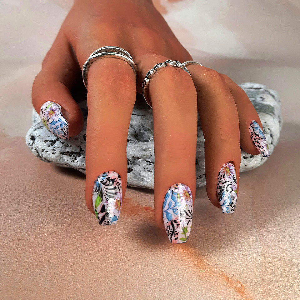 Pretty hand made press on nails with an abstract design of flowers, leaves, animal print and black swirls.