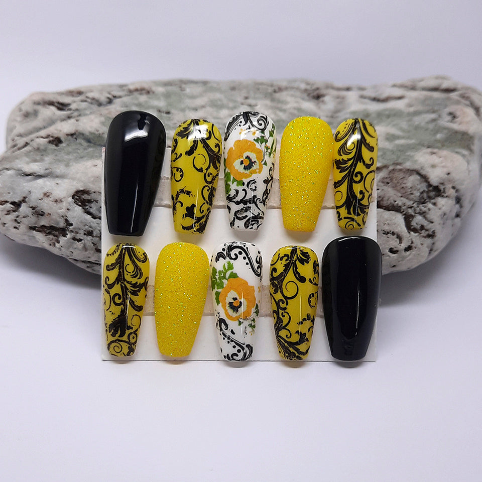 black,yellow and white hand made press on nails with glitter, flowers and black swirls
