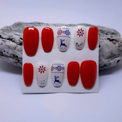red and white Christmas press on nails with a reindeer jumper design and silver flakes