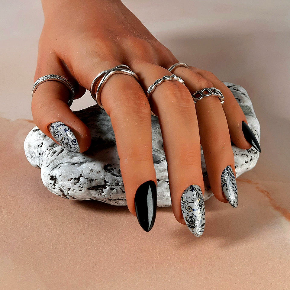 Black and grey hand made press on nails with a decorated black swirl design