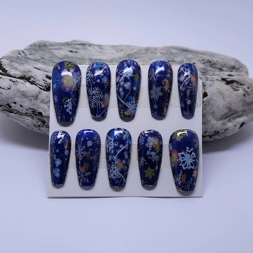 blue Christmas press on nails with an abstract snowflake design