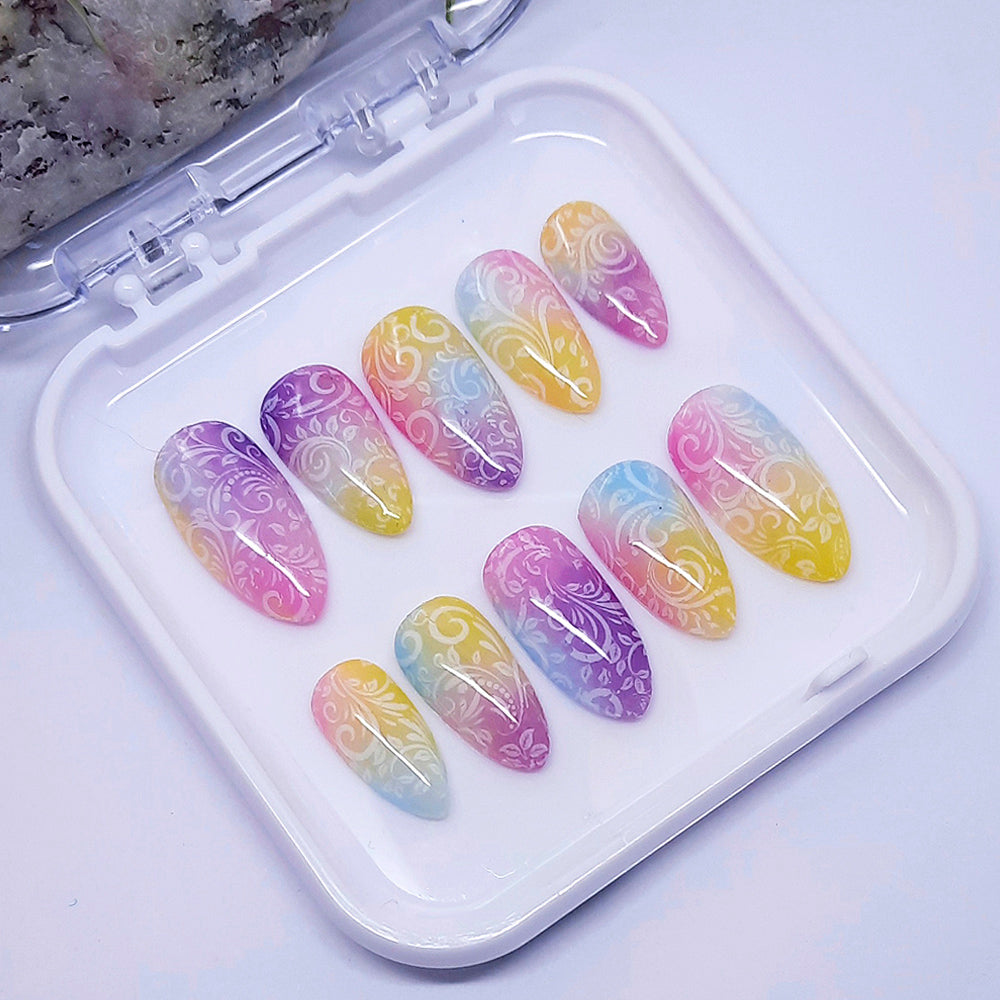 Set of colorful nail art designs in a clear case on a light background