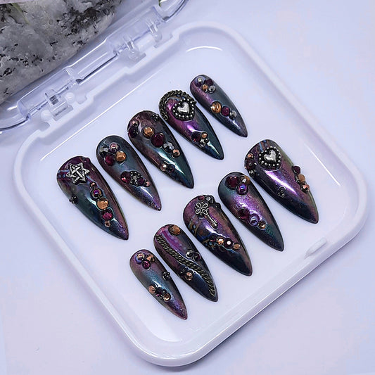 Decorative nails with gemstones on a white tray