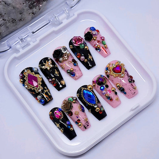 Decorative false nails with gemstones on a white tray