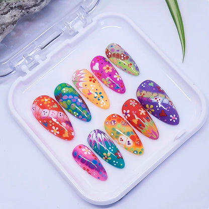Colorful nail art designs on a white tray with a light background