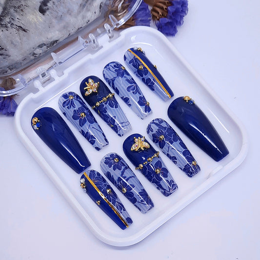 long coffin press on nails with blue flowers and gold butterfly nail charms