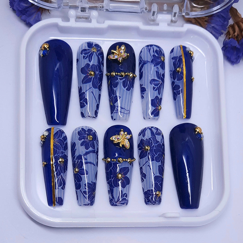 long coffin press on nails with blue flowers and gold butterfly nail charms