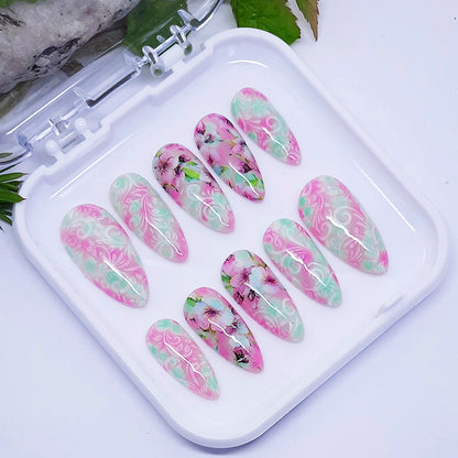 Set of floral nail art designs on a white tray with a natural background