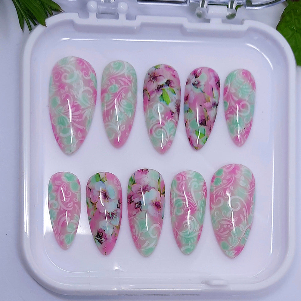 hand made almond press on nails in pastel pink and green with flowers and white vines