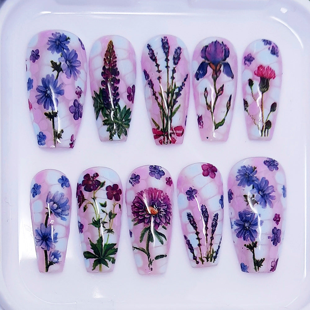 Nail art with floral designs on a white background