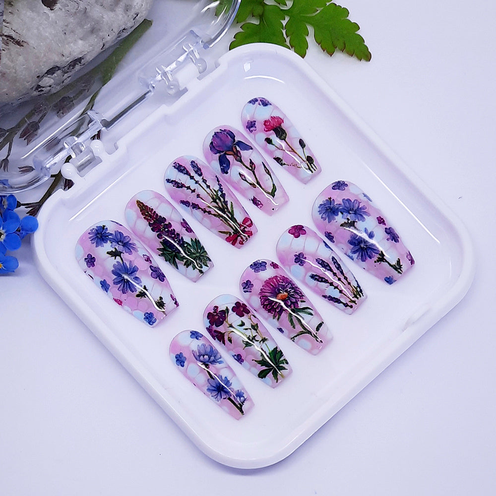Set of floral press on nail art designs on a white tray with a natural background