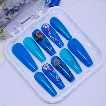 turquoise hand made press on nails, with a mixture of gels, flowers, and 3d nails art