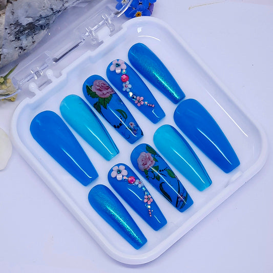 turquoise hand made press on nails, with a mixture of gels, flowers, and 3d nails art