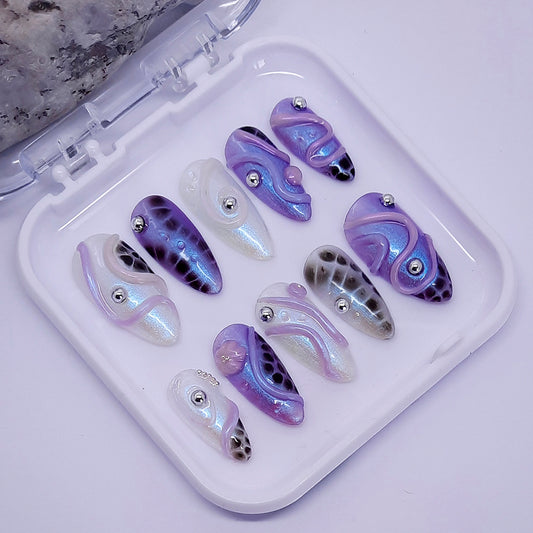 beautiful shimmering hand made press on nails with an abstract 3d design