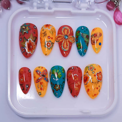 very colourful hand made press onnails with a floral design and 3d nail art