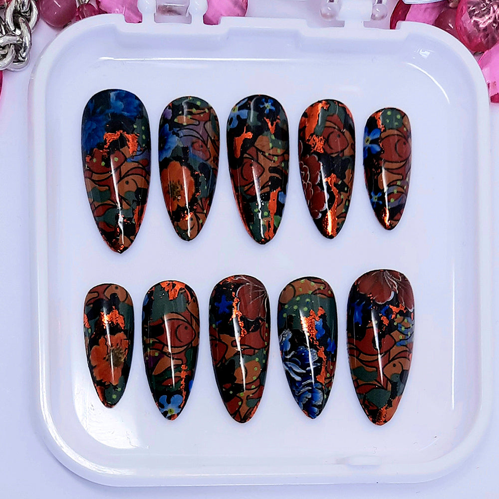 a stunning set of black almond press on nails with and abstract design of fish and flowers