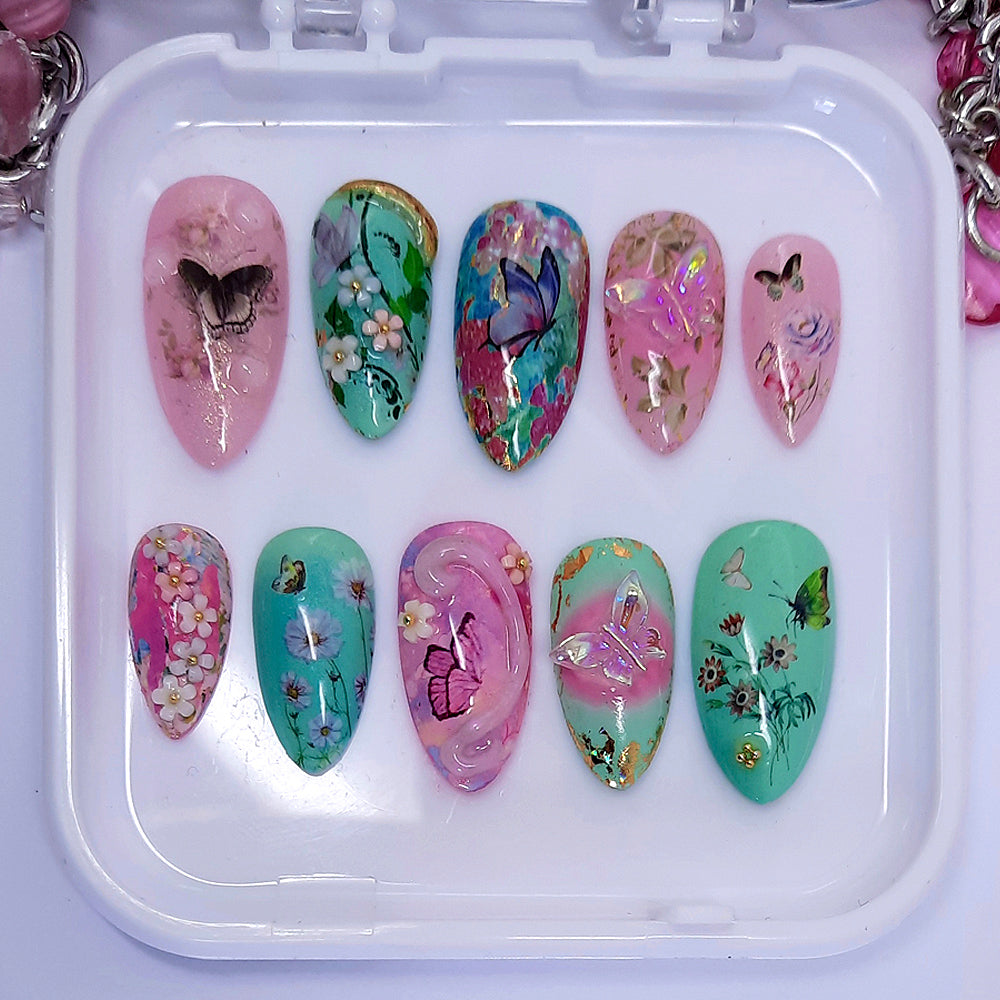 dreamy pink and green press on nails with butterflies, flowers, and 3d nails art