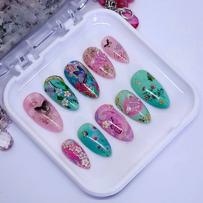 dreamy pink and green press on nails with butterflies, flowers, and 3d nails art