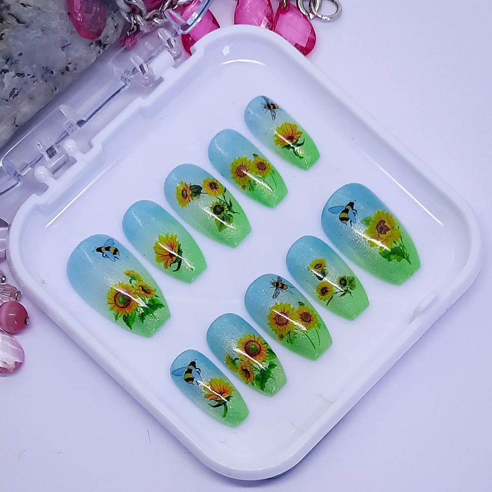 green and blue ombre shimmering press on nails with sunflowers and bees