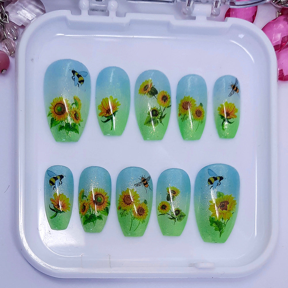 green and blue ombre shimmering press on nails with sunflowers and bees