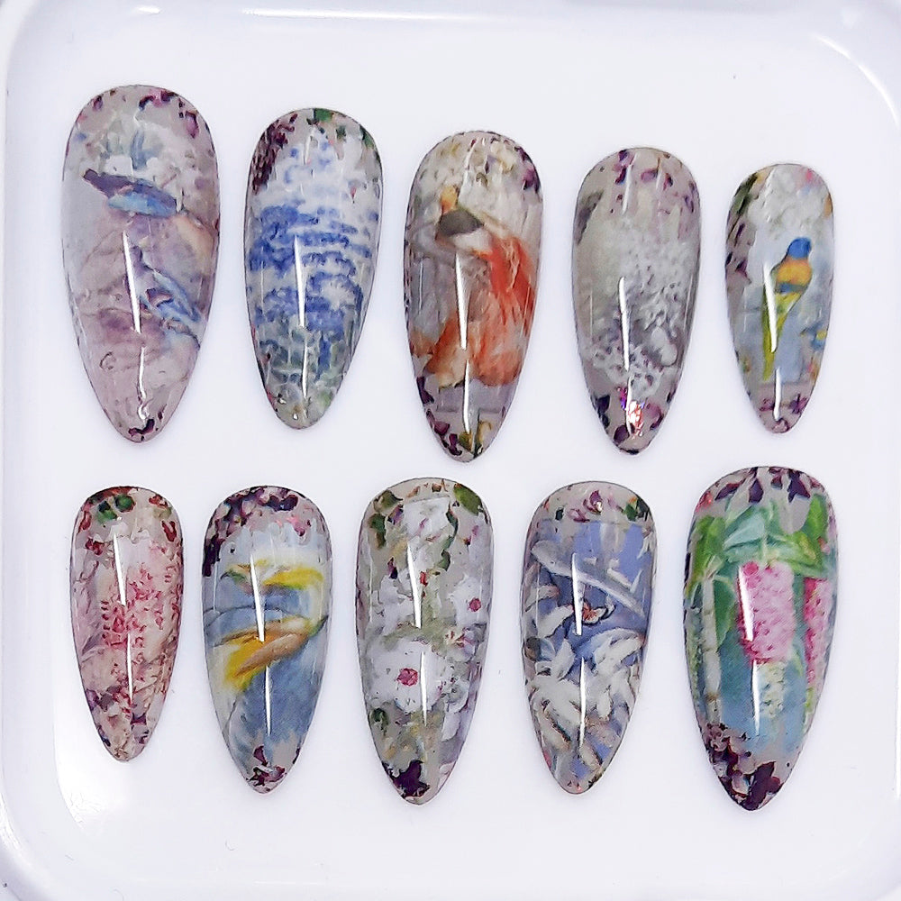 Set of nail art designs with floral and bird patterns on a white background