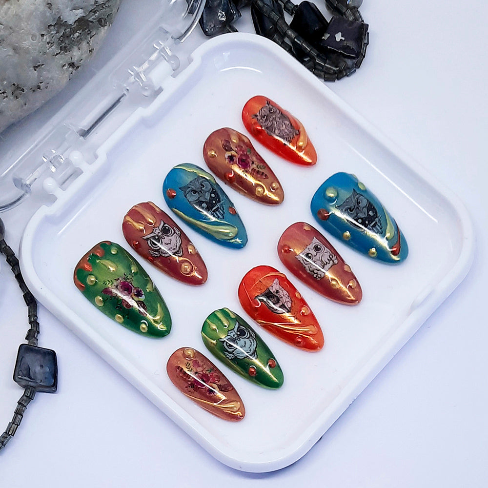 Set of colourful nail art designs with owls on a white tray with a white background