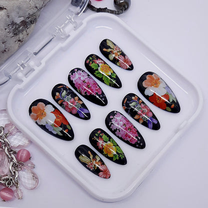 beautiful glossy black press on nails with large colourful flowers