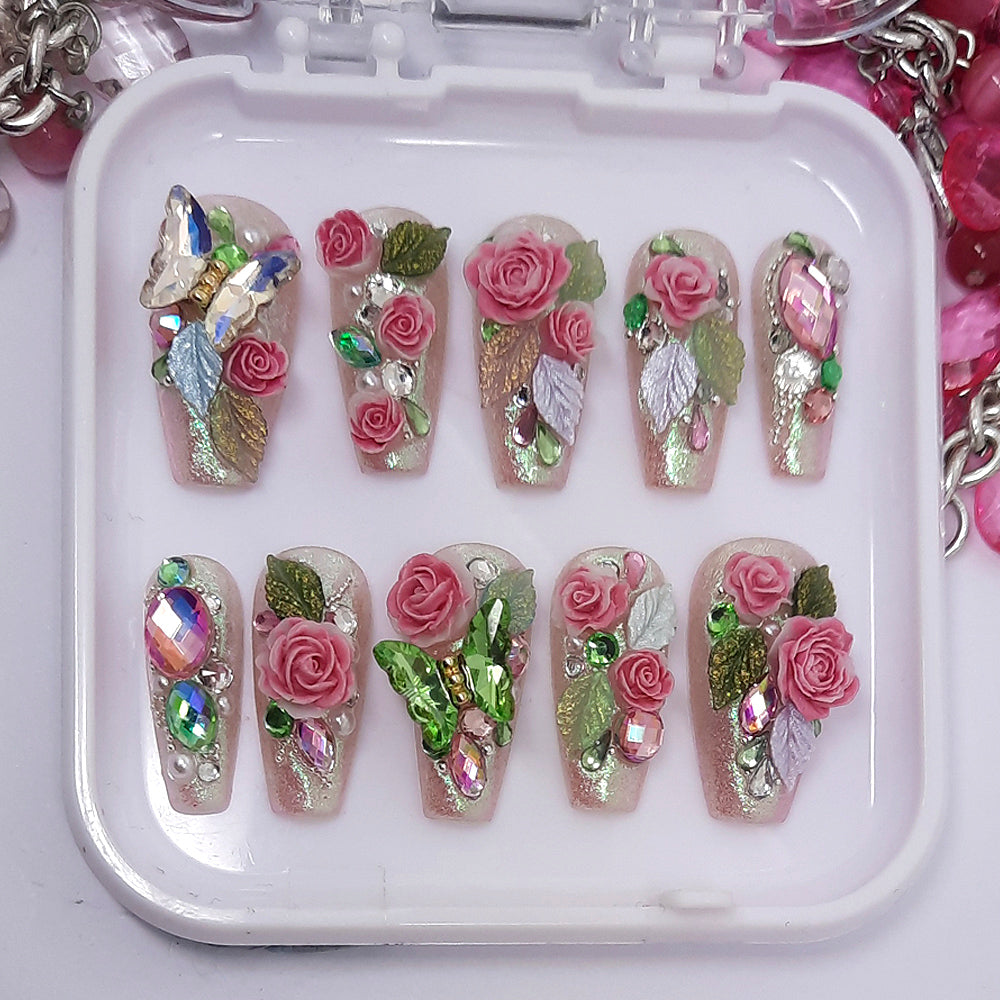 beautiful shimmering pink press on nails with 3d roses and leaves, butterflies, crystals and pearls.