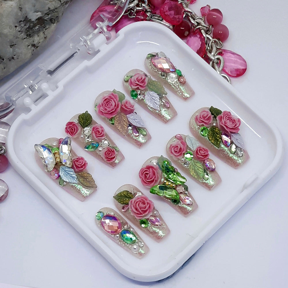 beautiful shimmering pink press on nails with 3d roses and leaves, butterflies, crystals and pearls.