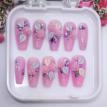 A beautiful set of press on nails, in a soft pink with white lace, 3d pink roses, leaves and crystals, giving wedding vibes.