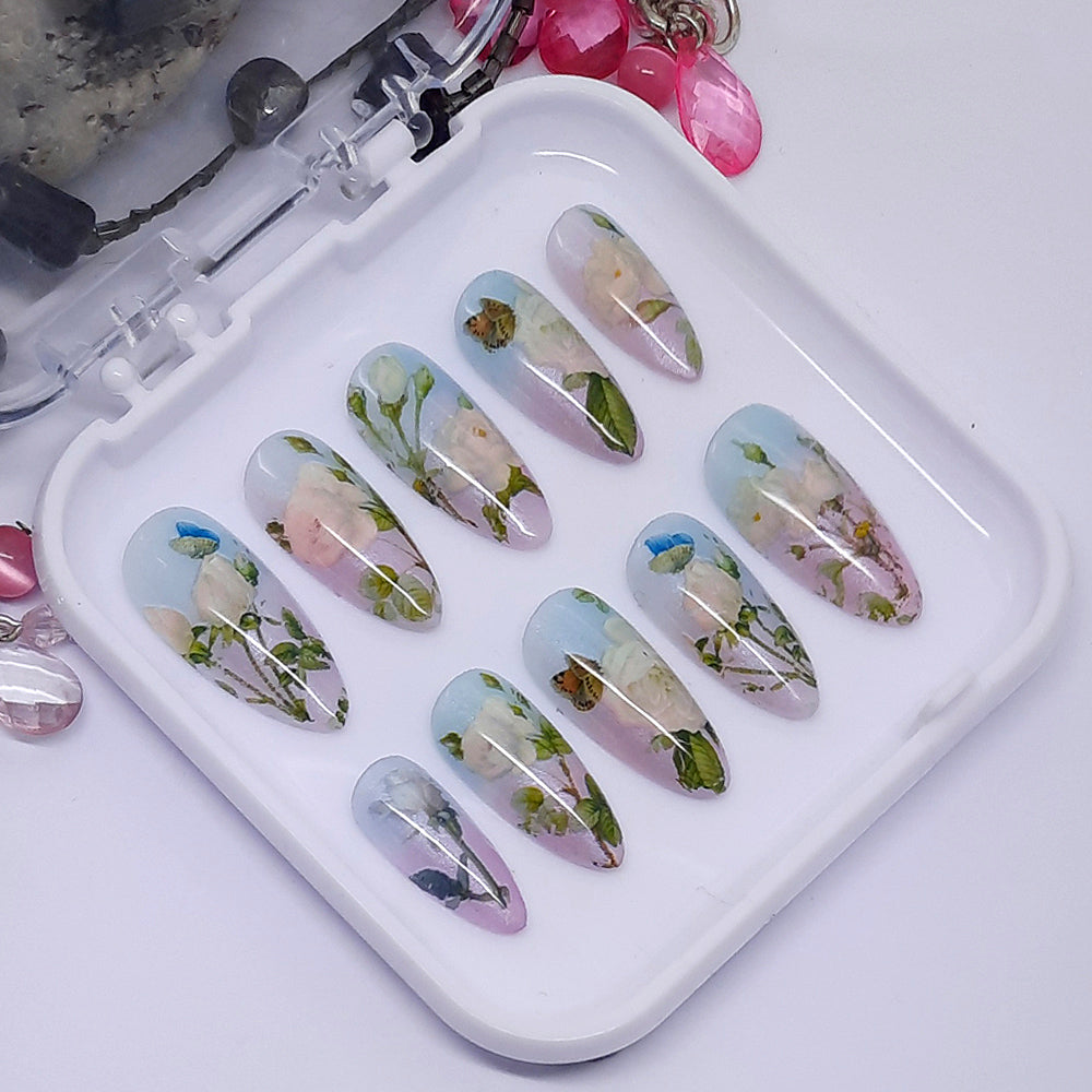 Beautiful press on nails in subtle colours, with white roses and butterflies.