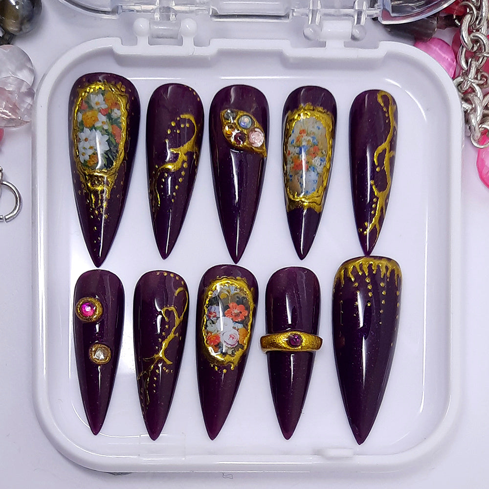 Beautiful sparkly deep purple press on nails with flowers, gold chrome and gems.