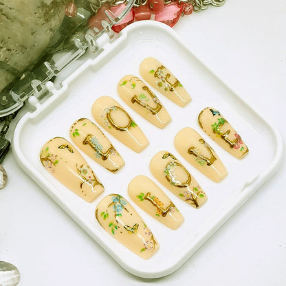 Beautiful press on nails in soft cream colour, with LOVE written in raised gold chrome and decorated with little flowers and butterflies. Finished in gloss top coat. These are so pretty.