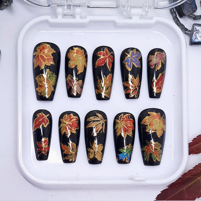 Set of nail art designs with autumn leaf patterns on black background