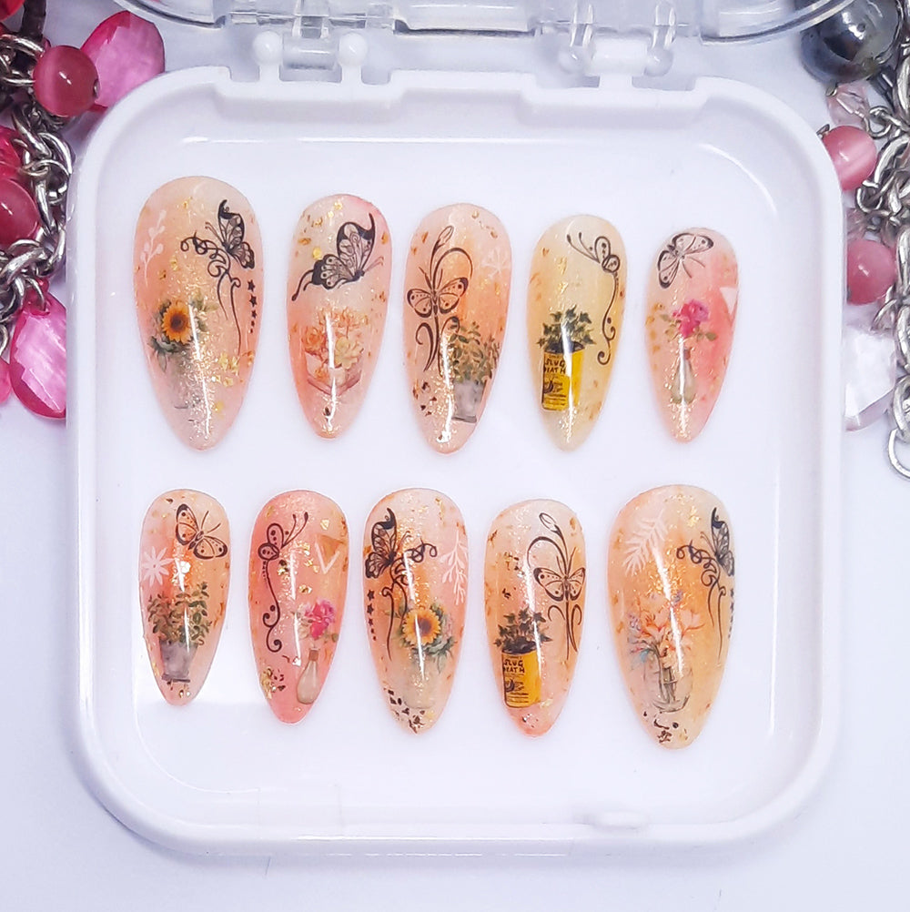 Set of decorative nail art designs on a white tray on a white background.