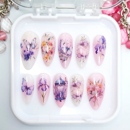 Set of nail art designs in a white case with floral and butterfly patterns.