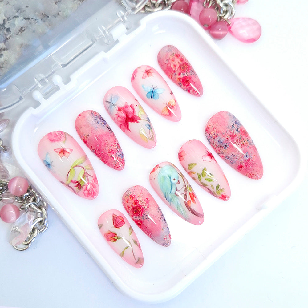 Set of floral nail art designs on press-on nails with a white tray.