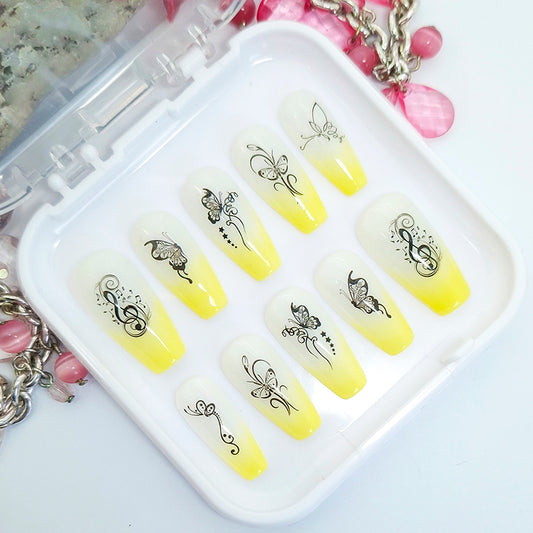 Yellow and white gradient nail art designs with black butterflies in a white case.
