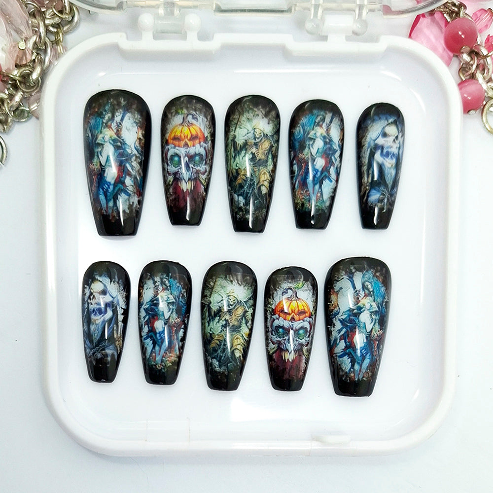 A set of ten coffin-shaped press-on nails with dark, gothic fantasy illustrations, displayed in a white plastic case on a white surface.