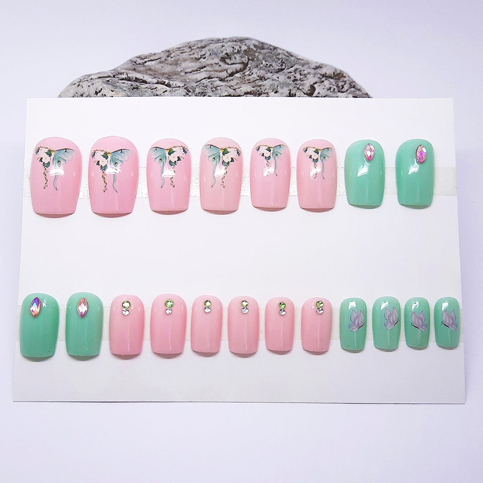 Set of pastel-colored nail art designs on a display card.
